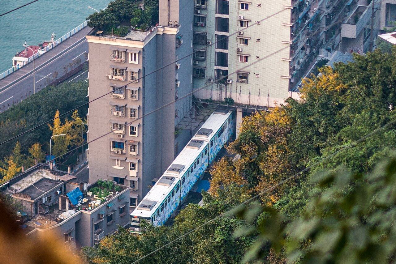 Chongqing Line 2 monorail train passing straight through an apartment building at Liziba Station